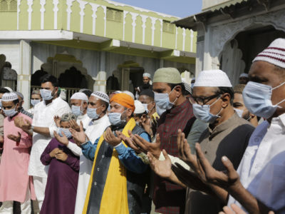 Indian Muslims wear masks and pray for the prevention of coronavirus in India. (AP Photo/Ajit Solanki)