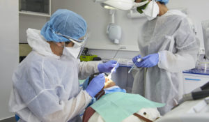 Dentist Dr. Afif, left, and his assistant wear protective suits and masks to avoid contamination with the COVID-19 virus at the Cheikh Hopital de Khalifa in Casablanca, Morocco. (AP Photo/ Abdeljalil Bounhar)