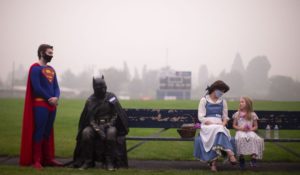 Belle, Superman and Batman play with children at the Silke Field evacuation site in Springfield, Oregon on Sept. 10. (Beth Nakamura/The Oregonian)