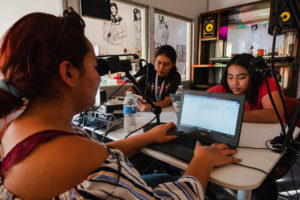 From left: Samantha Soto, Noemí Pedraza, work on Radio Pulso, Boyle Heights Beat's podcast, in early 2020, before the coronavirus pandemic. (Courtesy: Kris Kelley)