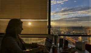 Photojournalist Amanda Rossmann edits video footage for the documentary '2020: The Year That Revealed Us' while working from the Cincinnati Enquirer office. (Photo by Meg Vogel/Cincinnati Enquirer)