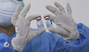 A health worker shows vials of the Moderna COVID-19 vaccine before she give shots to colleagues who have been previously vaccinated at Adam Malik Hospital in Medan, North Sumatra, Indonesia, Wednesday, Aug. 4, 2021. The U.S. just approved booster shots for immunocompromised people. Indonesia has begun administering booster shots to health workers. (AP Photo/Binsar Bakkara)