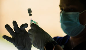 A syringe is prepared with the Pfizer COVID-19 vaccine at a clinic at the Reading Area Community College in Reading, Pa., Tuesday, Sept. 14, 2021. (AP Photo/Matt Rourke)