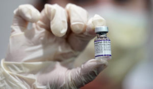 A health care worker holds a vial of the Pfizer COVID-19 vaccine at Jackson Memorial Hospital in Miami, in this Tuesday, Oct. 5, 2021, file photo. (AP Photo/Lynne Sladky, File)