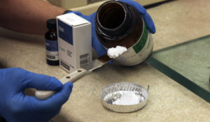 Pharmacist Donna Barsky measures potassium iodide for a prescription at the Texas Star Pharmacy on Tuesday, March 15, 2011 in Plano, Texas. At the time, the pharmacy  received an unusually high number of calls about potassium iodide from people who were afraid radiation from the Japan nuclear crisis would reach the U.S.(AP Photo/Richard Matthews)