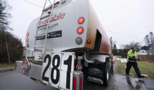 A sign on the back of deliveryman Daniel DiDonato’s heating oil truck indicates a price of $2.81 a gallon, Thursday, Dec. 16, 2021, in Lewiston, Maine. (AP Photo/Robert F. Bukaty)