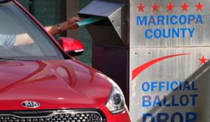 A voter casts their ballot at a secure ballot drop box at the Maricopa County Tabulation and Election Center in Phoenix on Tuesday. (AP Photo/Matt York)