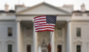 A flag is waved during an immigration rally outside the White House, in Washington, Sept. 4, 2017. (AP Photo/Carolyn Kaster, File)