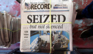 A stack of the weekly edition of the Marion County Record sits in the back of the newspaper's building, awaiting unbundling, sorting and distribution, Wednesday, Aug. 16, 2023, in Marion, Kan.  (AP Photo/John Hanna)