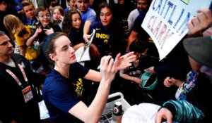 WNBA player Caitlin Clark signs autographs before a recent game in New York. (AP Photo/Noah K. Murray)