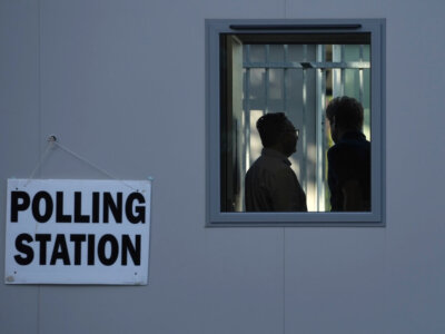 People vote in a temporary polling station next to Norbiton railway station London Thursday, July 4, 2024. Britain goes to the polls Thursday after Prime Minister Rishi Sunak called a general election. (AP Photo/Kin Cheung)