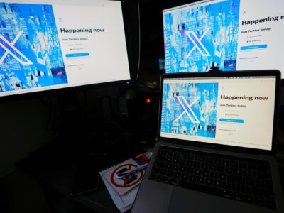 Computer monitors and a laptop display the X, formerly known as Twitter, sign-in page, July 24, 2023, in Belgrade, Serbia. (AP Photo/Darko Vojinovic, File)