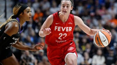 Indiana Fever guard Caitlin Clark (22) drives to the basket as Connecticut Sun guard DiJonai Carrington defends during a WNBA playoff game last Wednesday. (AP Photo/Jessica Hill)