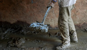 Grayson Jones cleans up on Thursday, Oct. 3, 2024, in Vilas, N.C. in the aftermath of Hurricane Helene. (AP Photo/Chris Carlson)