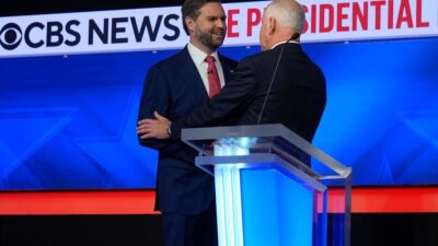 Vice presidential candidates JD Vance, left, and Tim Walz shake hands following Tuesday night’s VP debate. (AP Photo/Matt Rourke)