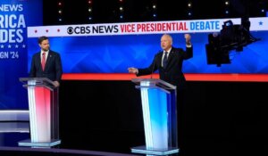 JD Vance, left, and Tim Walz meet in the vice presidential debate Tuesday night. (AP Photo/Matt Rourke)