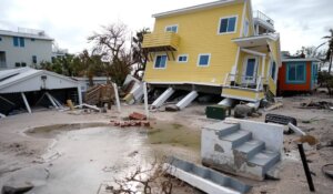 A house lies toppled off its stilts after the passage of Hurricane Milton last week in Bradenton Beach on Anna Maria Island, Fla. (AP Photo/Rebecca Blackwell)