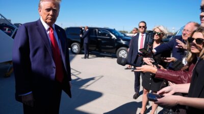 Former President Donald Trump speaks with reporters upon arrival at Philadelphia International Airport, Sunday, Oct. 20, 2024, in Philadelphia. (AP Photo/Evan Vucci)