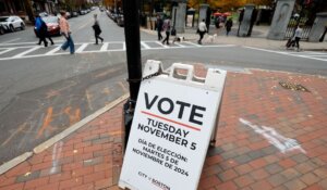 A sign urging people to vote is displayed at the intersection of Beacon and Charles Street over the weekend in Boston. (AP Photo/Michael Dwyer)