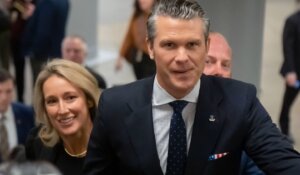 Pete Hegseth, President-elect Donald Trump's nominee to be defense secretary, is joined by his wife Jennifer Rauchet, as they walk through the basement of the Capitol in Washington on Wednesday. (AP Photo/Mark Schiefelbein)